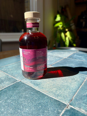 Bottle of whiskey on a tiled surface with a blurred background
