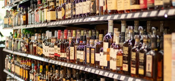 A line up of whisky bottles in a store