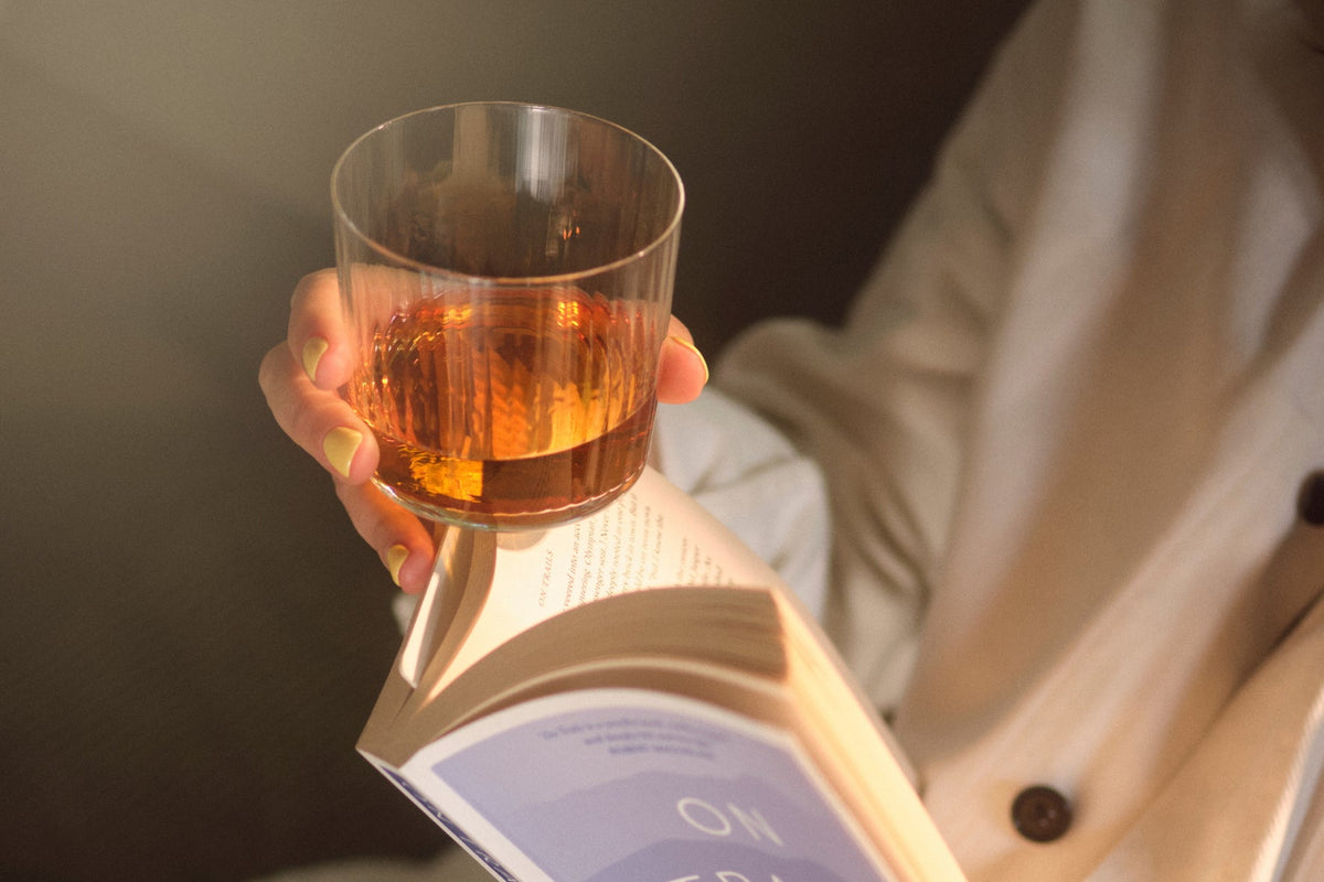 A glass of The Heart Cut Barley while reading a book