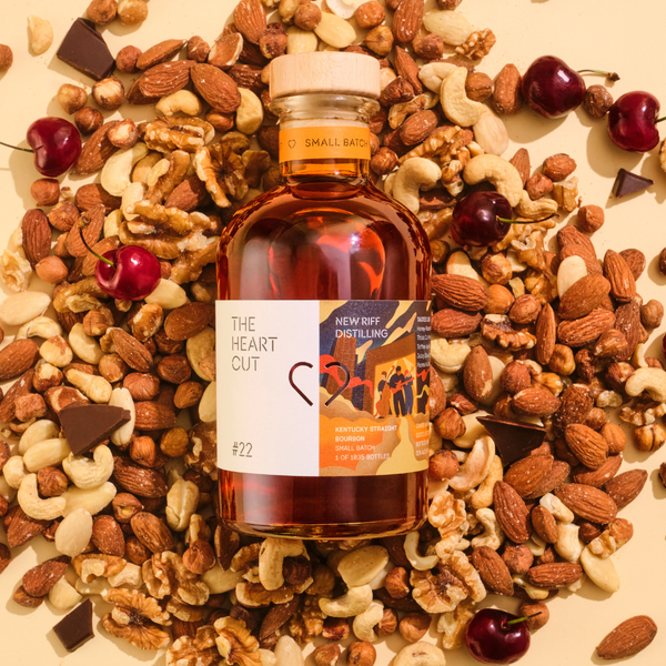 New Riff bourbon bottle on mixed nuts and snacks background
