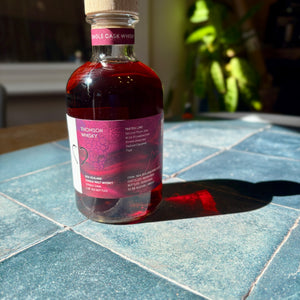 Bottle of whiskey on a tiled surface with a blurred background