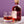 Bottle of 'The Heart Cut' whisky and a glass with whisky on a purple background