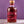 Bottle of The Heart Cut #19 Thomson on a light surface against a purple background